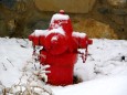 A firehydrant sits among the snow.