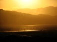 The western evening sky of Utah Valley depicting Utah Lake and mountains.
