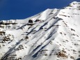 Jagged rocks poke through the snow-covered mountain.